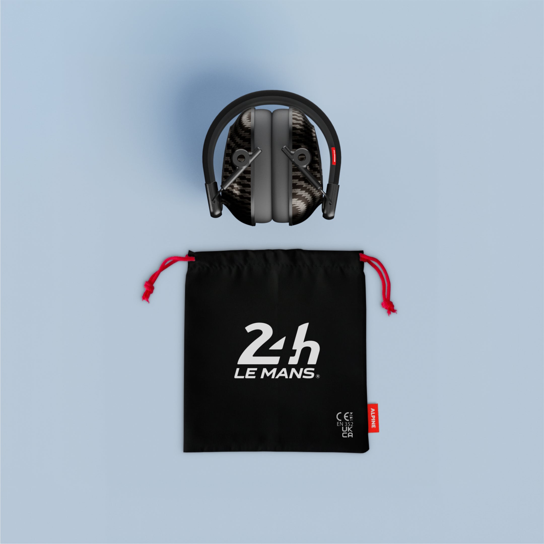 Folded Alpine 24h Le Mans Earmuffs above a black drawstring pouch with red cords and 24h Le Mans logo