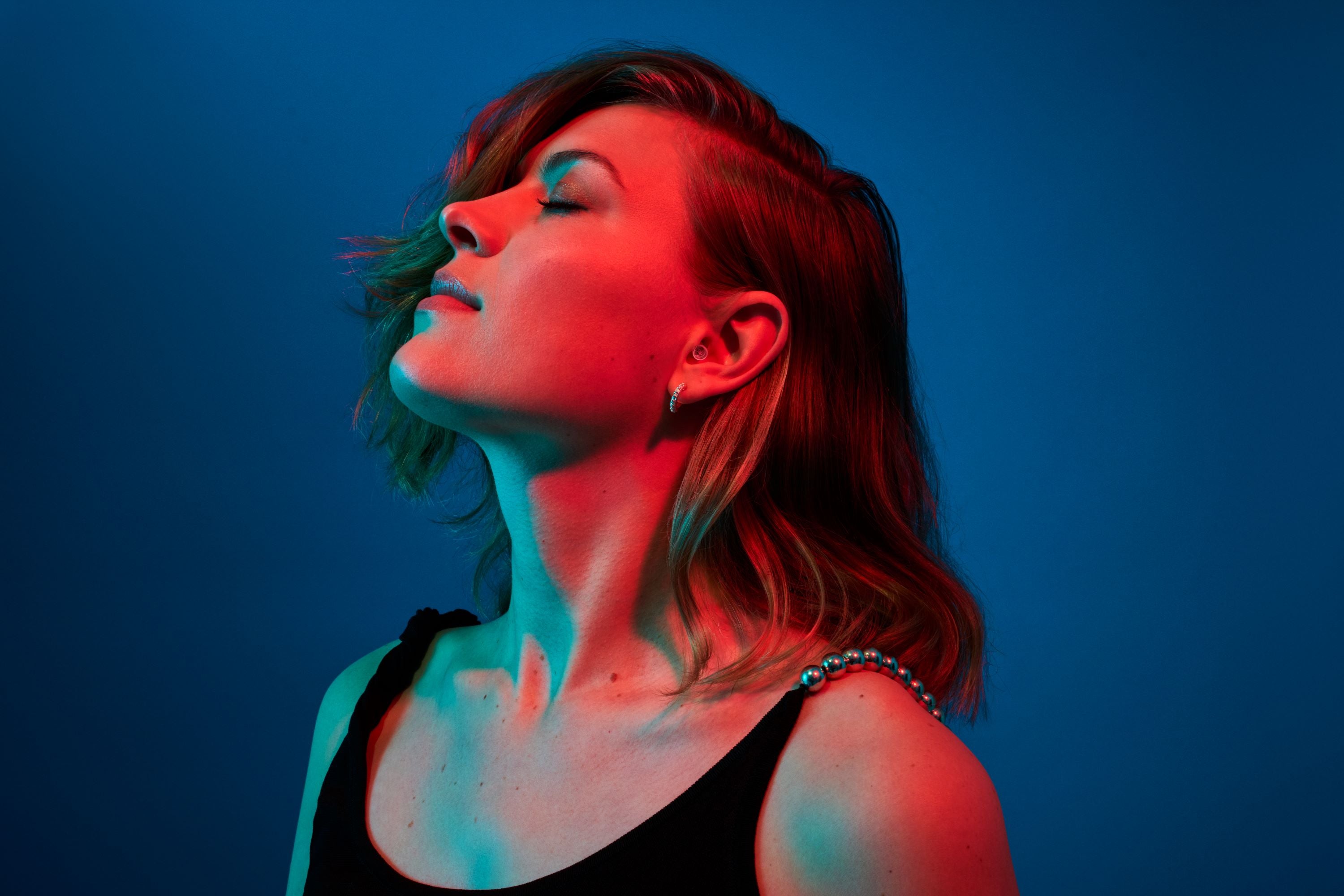 Woman wearing Alpine PartyPlug transparent earplugs at a party