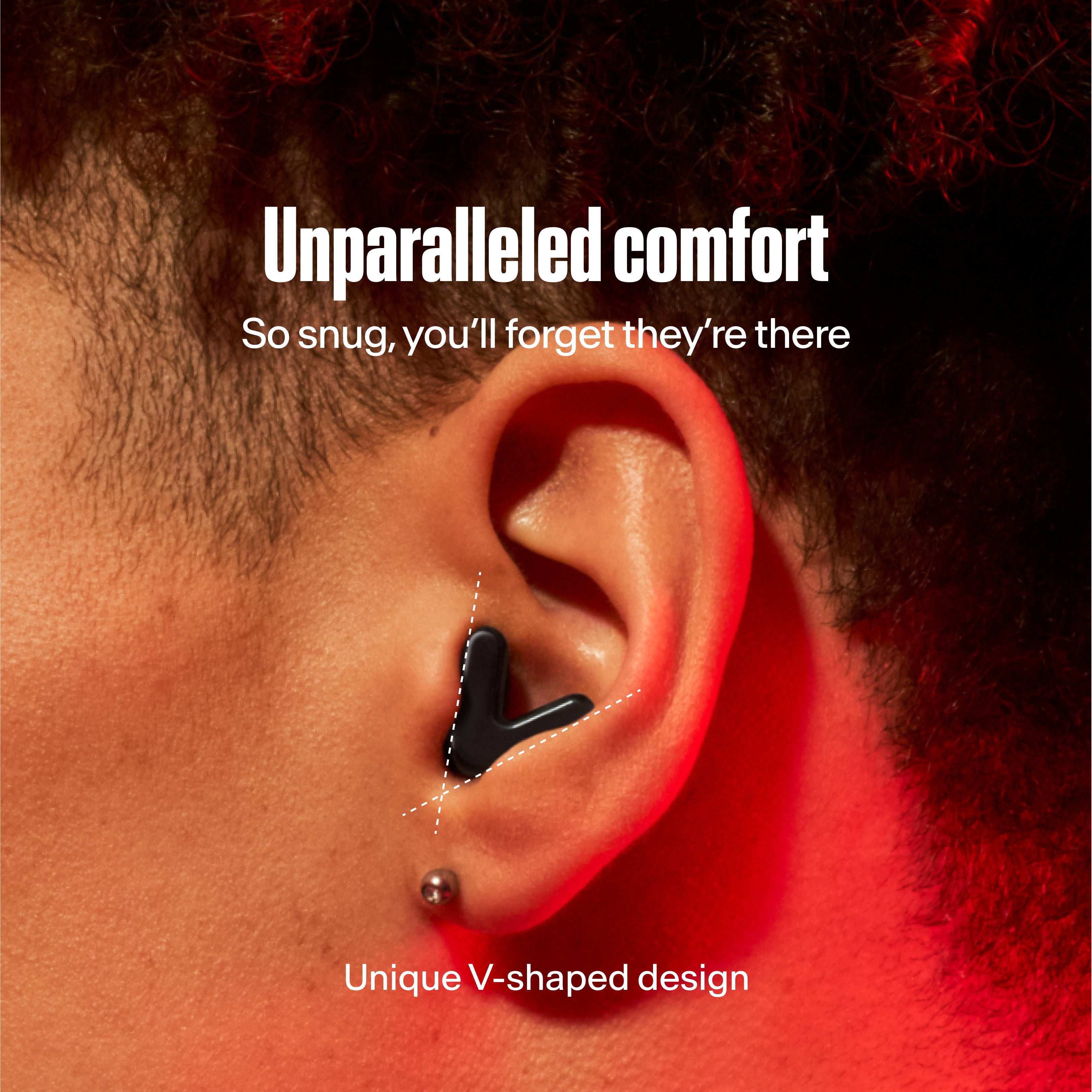 detailed image of an ear with an alpine tune earplug in black showing the snug fit in ear