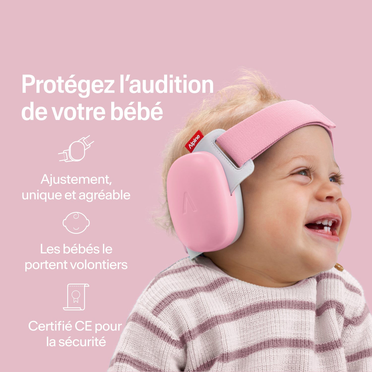 Bébé heureux portant des protège-oreilles Alpine rose-pink, ajustement sécurisé, protection auditive certifiée CE 
