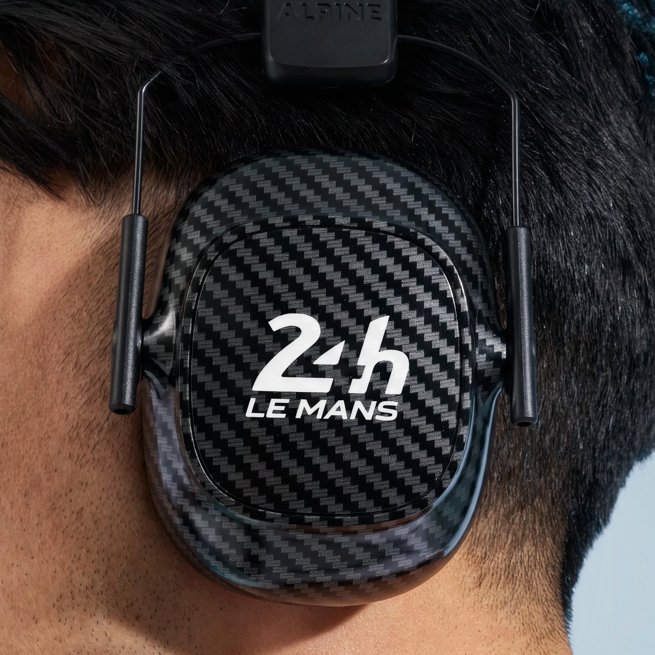 Alpine 24h Le Mans Earmuffs worn by a man with short dark hair, seen from behind 