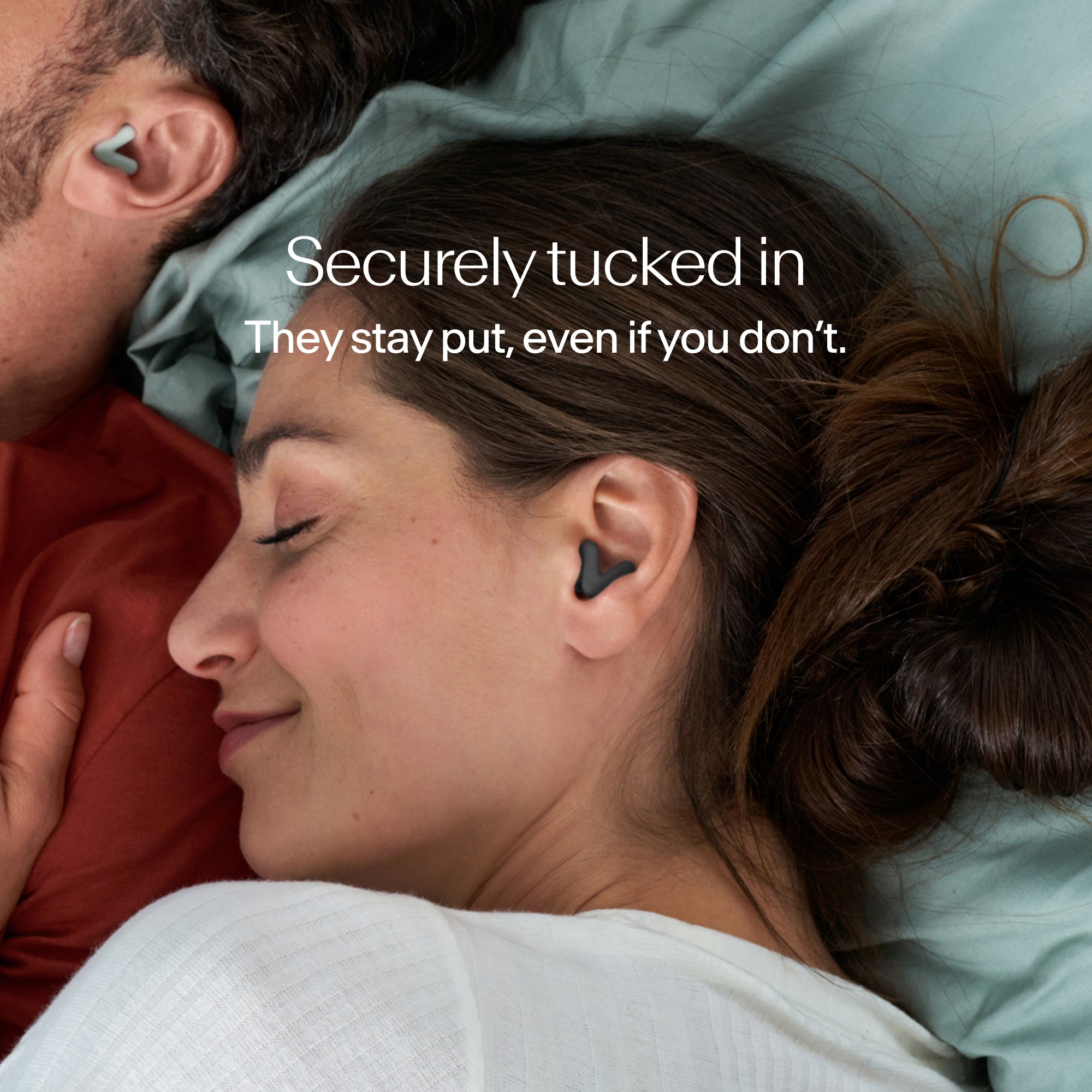 Man and woman sleeping, wearing Alpine Silence earplugs in black that stay securely in place 